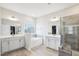 Luxury bathroom with dual vanities, soaking tub, and tiled glass shower at 251 North Crest Dr, Chapel Hill, NC 27517