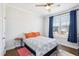 Bright bedroom with a ceiling fan, large windows, and comfortable bed, creating a welcoming atmosphere at 251 North Crest Dr, Chapel Hill, NC 27517