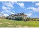 View of the rear of the clubhouse with neutral siding, well-manicured lawn, and a bright sky at 251 North Crest Dr, Chapel Hill, NC 27517