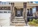 Inviting front porch with stone accents, sturdy columns, and iron railings leading to the front door at 251 North Crest Dr, Chapel Hill, NC 27517