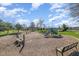 Community playground with various play structures, wood mulch, and surrounding greenery at 251 North Crest Dr, Chapel Hill, NC 27517