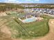 Aerial view of community pool, tennis courts, and clubhouse in an attractive neighborhood at 251 North Crest Dr, Chapel Hill, NC 27517