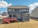Backyard view showcasing a two-story home with a spacious deck and a well-maintained lawn at 251 North Crest Dr, Chapel Hill, NC 27517