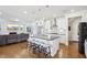 Open-concept kitchen with a large island, modern lighting, and white cabinetry at 251 North Crest Dr, Chapel Hill, NC 27517
