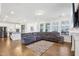 Open living space featuring hardwood floors, a gray sectional sofa, and abundant natural light at 251 North Crest Dr, Chapel Hill, NC 27517