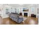 Comfortable living area with hardwood floors, gray reclining sofa, fireplace, and large windows at 251 North Crest Dr, Chapel Hill, NC 27517