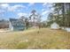 Expansive backyard with mature trees and a storage shed, perfect for outdoor activities at 2601 Forestville Rd, Wake Forest, NC 27587