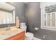 A vintage bathroom with patterned wallpaper, a vanity with marble countertops, and traditional fixtures at 2601 Forestville Rd, Wake Forest, NC 27587