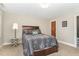 A comfortable bedroom with a full-sized bed, carpeted floors, and a side table at 2601 Forestville Rd, Wake Forest, NC 27587
