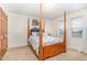 Well-lit bedroom with four poster bed, carpet flooring, and large windows at 2601 Forestville Rd, Wake Forest, NC 27587