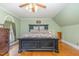 Bedroom featuring a large bed, wood flooring, and lots of natural light at 2601 Forestville Rd, Wake Forest, NC 27587