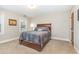 A comfortable bedroom with a full-sized bed, carpeted floors, and a window at 2601 Forestville Rd, Wake Forest, NC 27587
