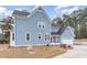Charming two-story home features blue siding, white trim, and an attached garage at 2601 Forestville Rd, Wake Forest, NC 27587