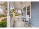 Inviting front porch with rocking chair, hanging plants and a porch swing at 2601 Forestville Rd, Wake Forest, NC 27587