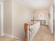 Hallway features carpet floors, natural lighting, and white wood railing at 2601 Forestville Rd, Wake Forest, NC 27587