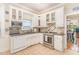 Bright kitchen featuring white cabinets, tile backsplash, stainless steel appliances, and tile floors at 2601 Forestville Rd, Wake Forest, NC 27587