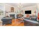 Cozy living room featuring hardwood floors, a fireplace, and comfortable seating at 2601 Forestville Rd, Wake Forest, NC 27587
