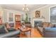 Cozy living room featuring hardwood floors, a fireplace, and comfortable seating at 2601 Forestville Rd, Wake Forest, NC 27587
