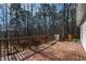 Wooden back deck offers a serene view of the surrounding woods and mature trees, an ideal outdoor space at 2776 Jordan Ct, Creedmoor, NC 27522