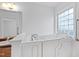 This bathroom showcases a modern walk-in bathtub next to a glass block window for privacy and light at 2776 Jordan Ct, Creedmoor, NC 27522