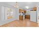 Cozy kitchen with wooden cabinets, laminate counters, and ample natural light from a large window at 2776 Jordan Ct, Creedmoor, NC 27522