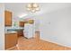 Functional kitchen area with wooden cabinets, white appliances, and hardwood flooring extending into the dining area at 2776 Jordan Ct, Creedmoor, NC 27522