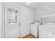 Functional laundry area equipped with a washer, dryer, and shelving, with a door to the outside at 2776 Jordan Ct, Creedmoor, NC 27522