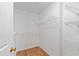 Bright walk-in closet features white walls, wood-look floor, and wire shelving for optimal storage at 2776 Jordan Ct, Creedmoor, NC 27522