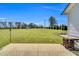 Expansive backyard featuring a well-manicured lawn, mature trees, and a storage shed in the distance at 28 Sandcastle Ln, Four Oaks, NC 27524