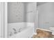 A relaxing soaking tub is featured in this bright and airy bathroom at 28 Sandcastle Ln, Four Oaks, NC 27524