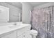 Bright bathroom with white vanity, modern fixtures, and a shower with a stylish floral curtain at 28 Sandcastle Ln, Four Oaks, NC 27524