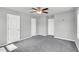 A spacious bedroom with neutral walls, carpet, and multiple doors for ample closet space at 28 Sandcastle Ln, Four Oaks, NC 27524