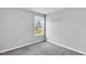 Cozy bedroom with carpeted floors, gray walls, a window with outside views, and natural light at 28 Sandcastle Ln, Four Oaks, NC 27524