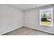 This is a light and airy bedroom with neutral decor and a large window with a great outdoor view at 28 Sandcastle Ln, Four Oaks, NC 27524