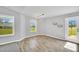 Bright dining area featuring wood floors, modern lighting, and a glass door leading to the backyard at 28 Sandcastle Ln, Four Oaks, NC 27524
