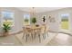 Bright dining room with stylish light fixture, modern decor and view to backyard at 28 Sandcastle Ln, Four Oaks, NC 27524