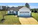 Charming single-story home with well-maintained lawn and attached two-car garage at 28 Sandcastle Ln, Four Oaks, NC 27524