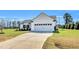 Well-maintained one-story home with a two-car garage, neat landscaping, and a long concrete driveway at 28 Sandcastle Ln, Four Oaks, NC 27524