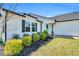 Close-up of a charming home with white siding, black shutters, and a bright blue front door at 28 Sandcastle Ln, Four Oaks, NC 27524