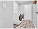 Laundry room featuring modern washer and dryer, patterned flooring, and ample storage space at 28 Sandcastle Ln, Four Oaks, NC 27524