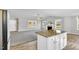 Open-concept living area features fireplace, ample natural light, and seamless flow from the kitchen with island at 28 Sandcastle Ln, Four Oaks, NC 27524