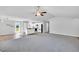Bright living room seamlessly integrates a dining area and a modern kitchen with white cabinets and black appliances at 28 Sandcastle Ln, Four Oaks, NC 27524