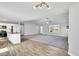 Open-concept living area showcases wood flooring, gray walls, modern lighting, and seamlessly connects to the kitchen at 28 Sandcastle Ln, Four Oaks, NC 27524