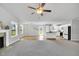 Open concept living space with a fireplace, large windows, and a view of the kitchen and backyard at 28 Sandcastle Ln, Four Oaks, NC 27524