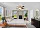 The main bedroom features a ceiling fan, natural light, and decorative wallpaper between the windows at 28 Sandcastle Ln, Four Oaks, NC 27524