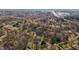 An aerial view of a quiet neighborhood showcasing mature trees and the home's surroundings and neighborhood streets at 3001 Blanche Dr, Burlington, NC 27215