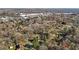 An aerial view shows the neighborhood with mature trees, a shopping center, and the home's proximity to local amenities at 3001 Blanche Dr, Burlington, NC 27215
