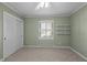 Cozy bedroom featuring carpet flooring, built-in shelves, and a large window at 3001 Blanche Dr, Burlington, NC 27215