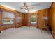 Spacious bedroom with wood paneled walls, carpet flooring, and natural light at 3001 Blanche Dr, Burlington, NC 27215