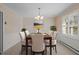 Dining room showcasing neutral color palette, elegant light fixture, and shuttered windows at 3001 Blanche Dr, Burlington, NC 27215
